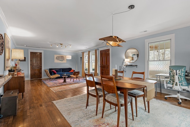 dining area featuring crown molding and wood-type flooring