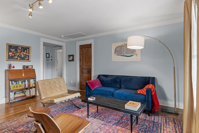 living room with crown molding, dark wood-type flooring, and track lighting