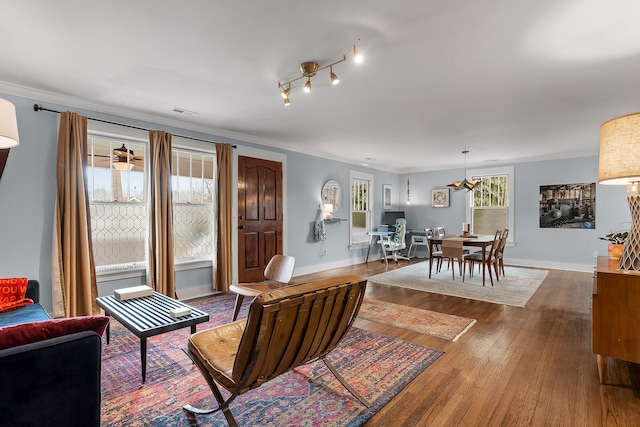 living room with ornamental molding and dark hardwood / wood-style floors