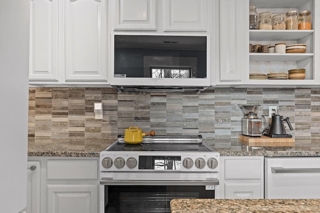 kitchen with stainless steel range with electric stovetop, dark stone counters, and white cabinets