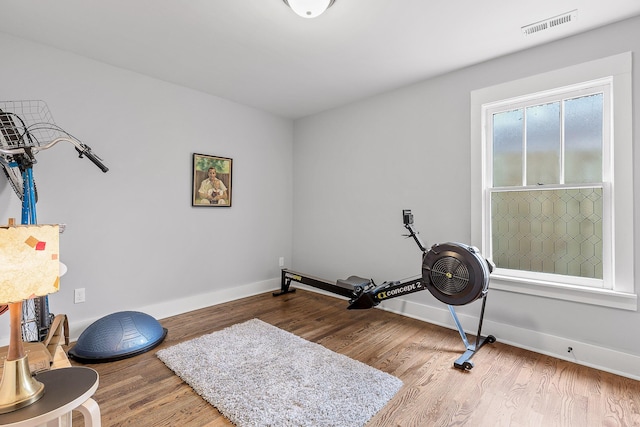 workout area with hardwood / wood-style floors