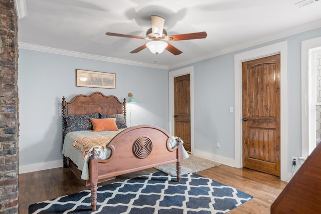 bedroom featuring wood-type flooring, ornamental molding, and ceiling fan