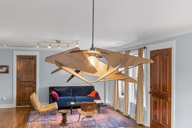 living area featuring crown molding, wood-type flooring, and rail lighting