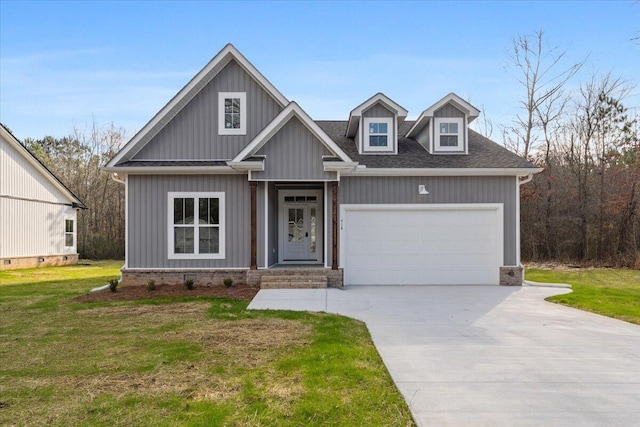 craftsman-style home featuring a garage and a front lawn