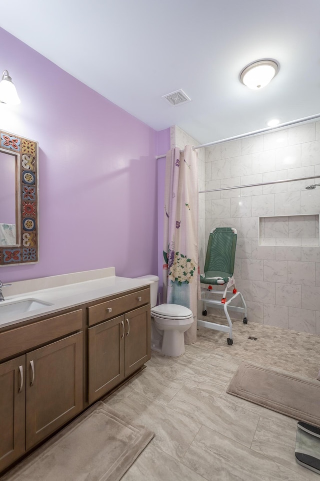 bathroom featuring vanity, curtained shower, and toilet