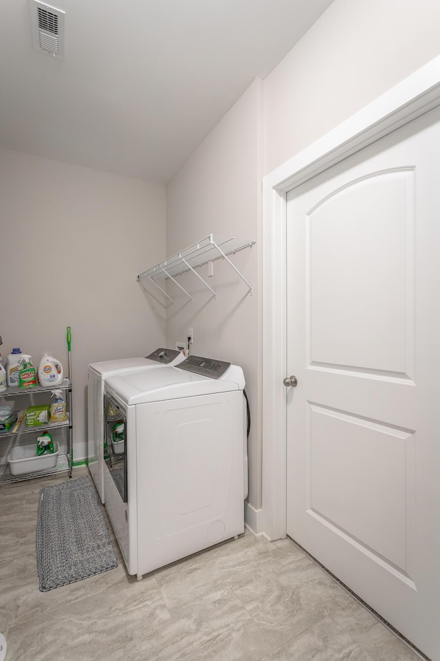 clothes washing area with washer and dryer