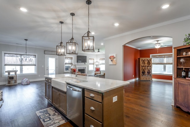 kitchen with sink, decorative light fixtures, dark hardwood / wood-style floors, dishwasher, and an island with sink