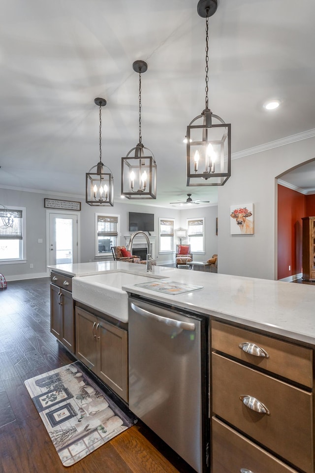 kitchen featuring dark hardwood / wood-style floors, pendant lighting, dishwasher, sink, and crown molding