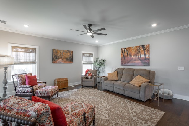 living room with crown molding, dark wood-type flooring, and ceiling fan