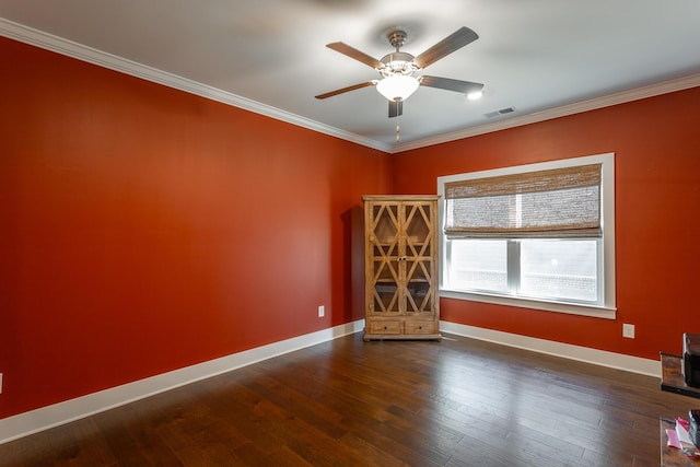 spare room featuring crown molding, dark hardwood / wood-style floors, and ceiling fan