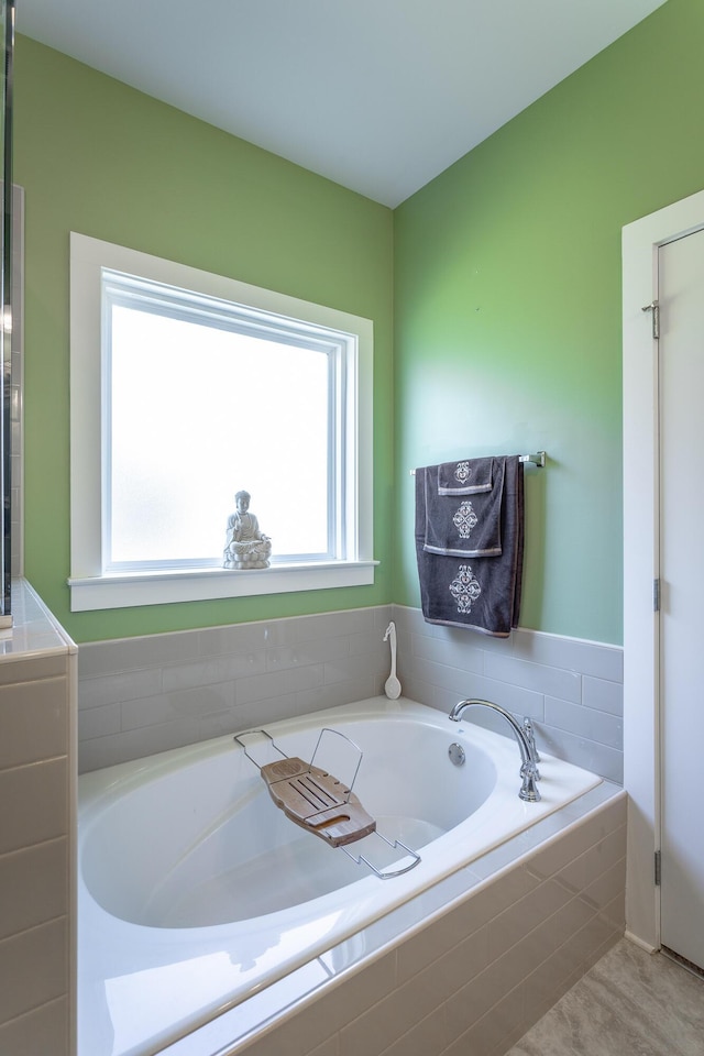 bathroom featuring tiled tub