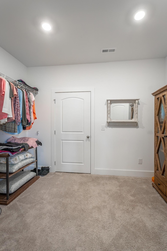 walk in closet with carpet flooring