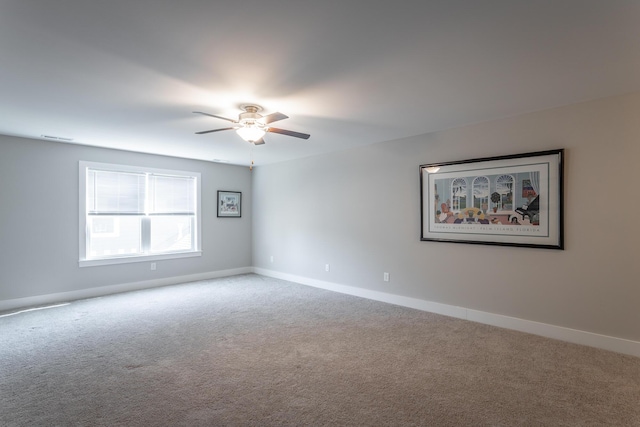 carpeted spare room with ceiling fan