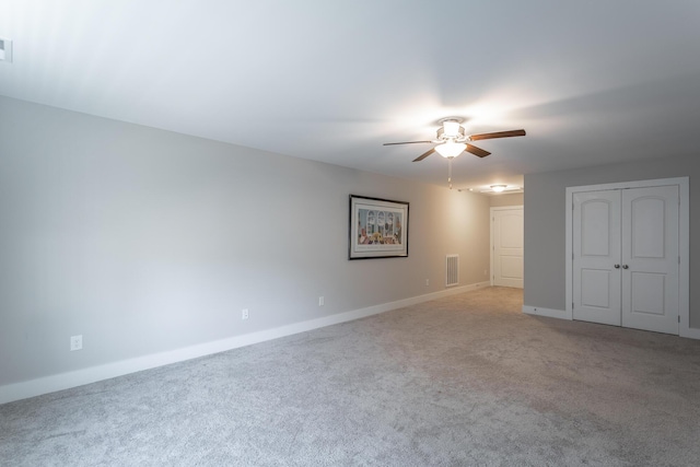 unfurnished room with light colored carpet and ceiling fan