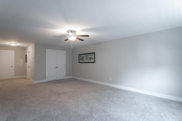 empty room featuring light colored carpet and ceiling fan