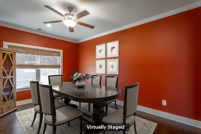 dining area featuring crown molding, dark wood-type flooring, and ceiling fan