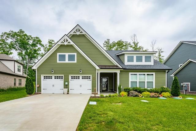 craftsman house with a shingled roof, driveway, and a front lawn