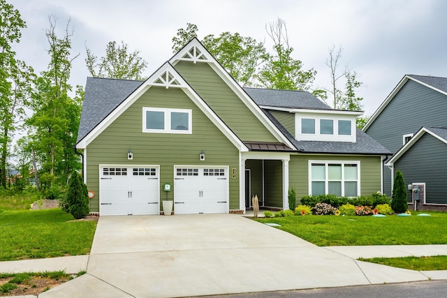 craftsman-style home with an attached garage, roof with shingles, driveway, and a front yard