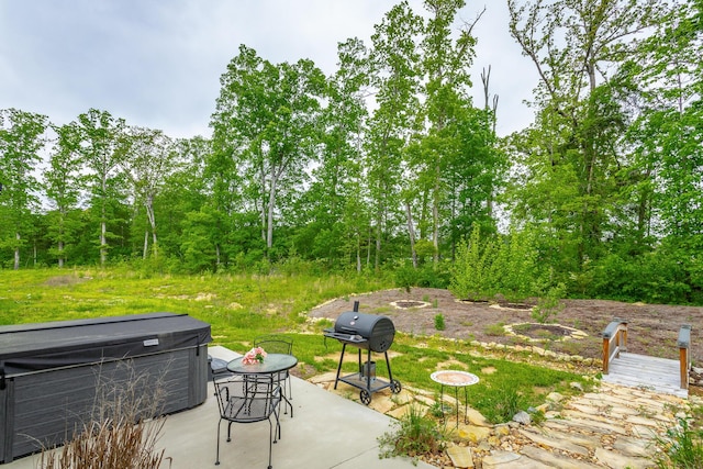 view of patio / terrace with a hot tub and area for grilling