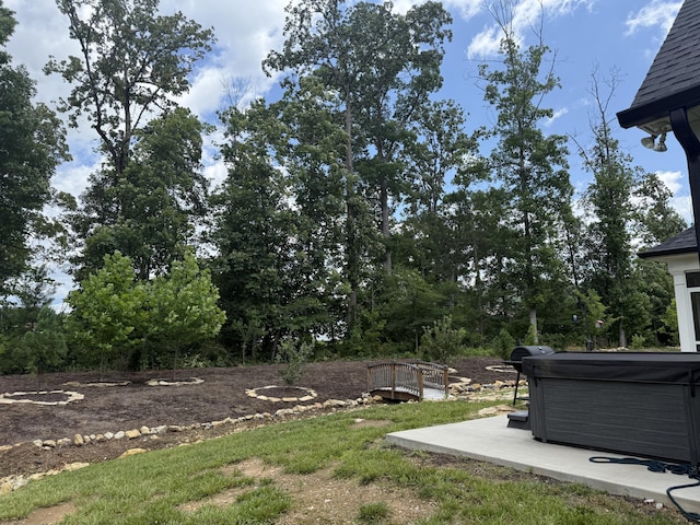 1502 Buttonwood Loop, Chattanooga, TN 37421 - view of yard featuring a hot tub, a patio, and view of wooded area