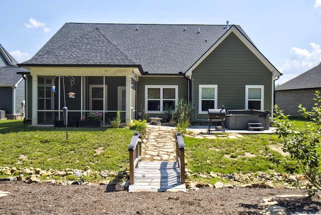 1502 Buttonwood Loop, Chattanooga, TN 37421 - back of property with a hot tub, a shingled roof, a sunroom, a patio area, and a yard