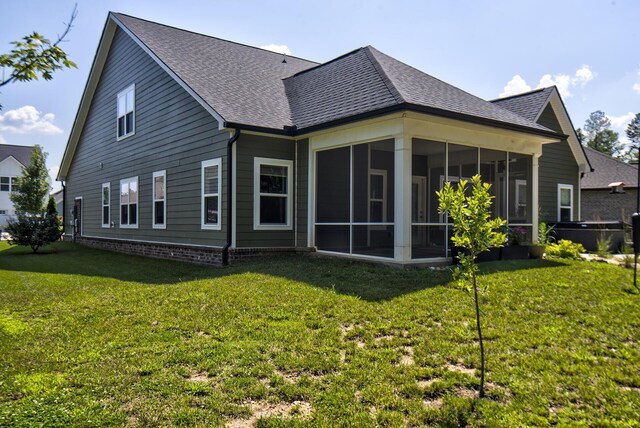 1502 Buttonwood Loop, Chattanooga, TN 37421 - back of property with a sunroom, a lawn, and roof with shingles