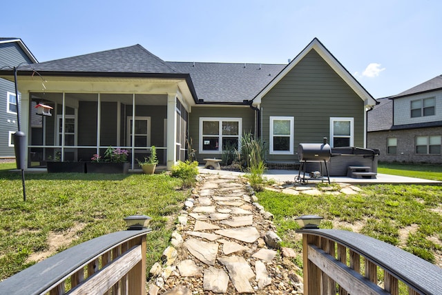 1502 Buttonwood Loop, Chattanooga, TN 37421 - back of property featuring a hot tub, roof with shingles, a sunroom, a patio area, and a yard