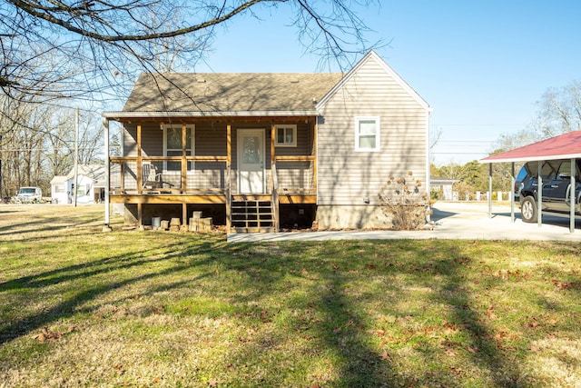 rear view of house featuring a yard and covered porch