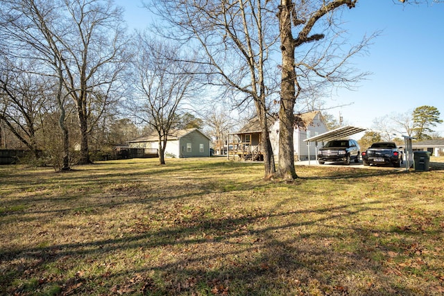 view of yard featuring a carport and a porch