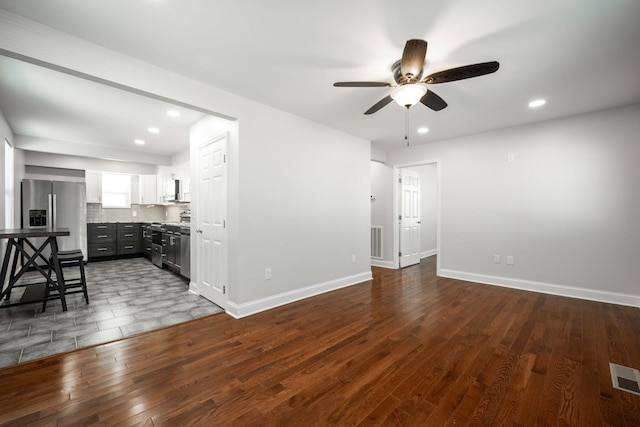 unfurnished living room with ceiling fan and dark hardwood / wood-style floors