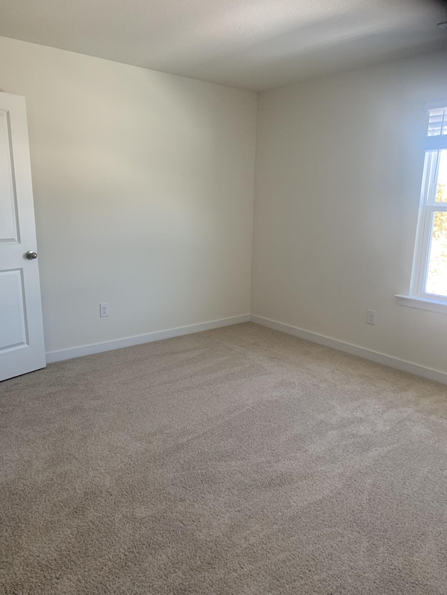 unfurnished room with light carpet