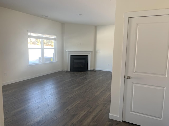 unfurnished living room featuring dark hardwood / wood-style floors