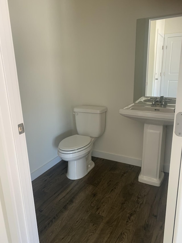 bathroom with wood-type flooring and toilet