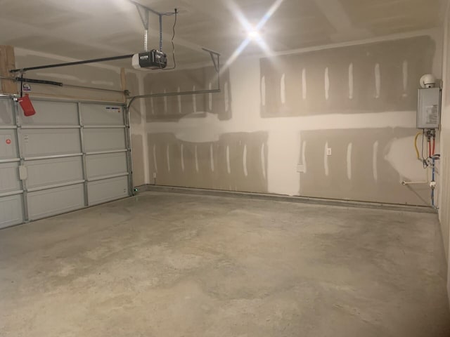 garage with a garage door opener and water heater