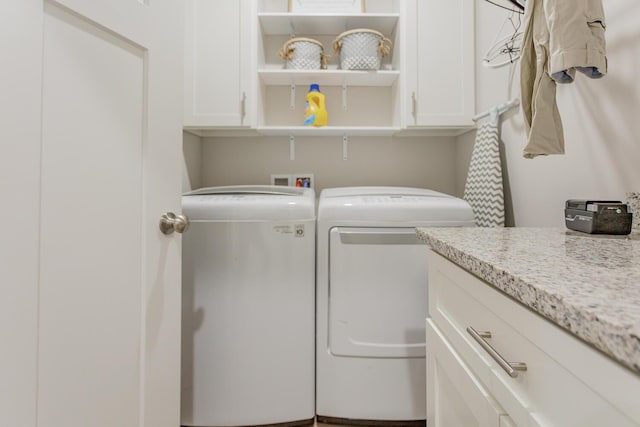 laundry area with cabinets and washing machine and clothes dryer