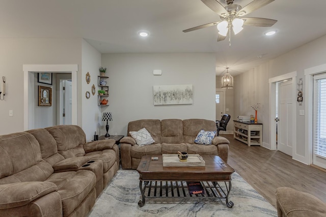 living room featuring hardwood / wood-style floors and ceiling fan