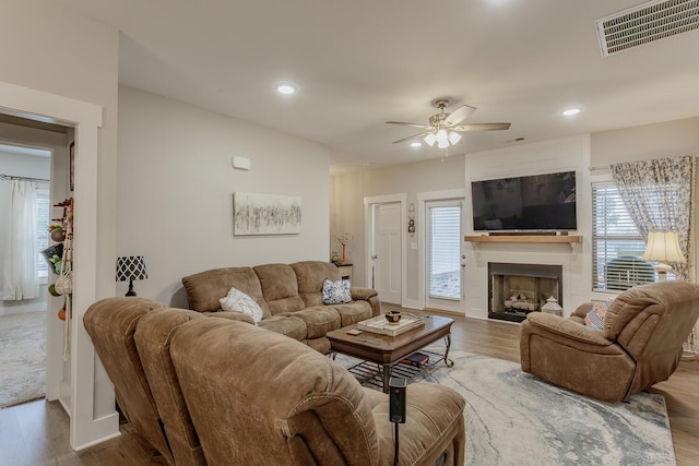 living room featuring ceiling fan and light hardwood / wood-style floors