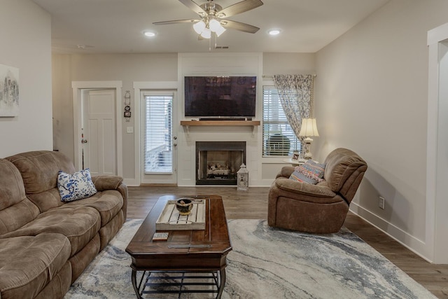 living room featuring hardwood / wood-style flooring and ceiling fan