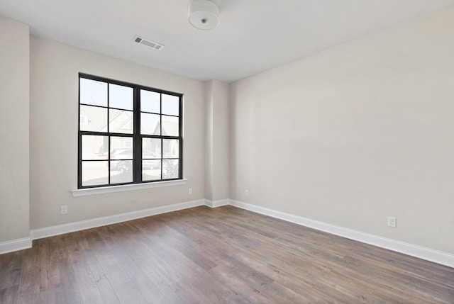 unfurnished room featuring hardwood / wood-style flooring