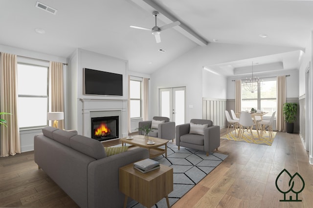 living room with french doors, ceiling fan, wood-type flooring, and lofted ceiling with beams