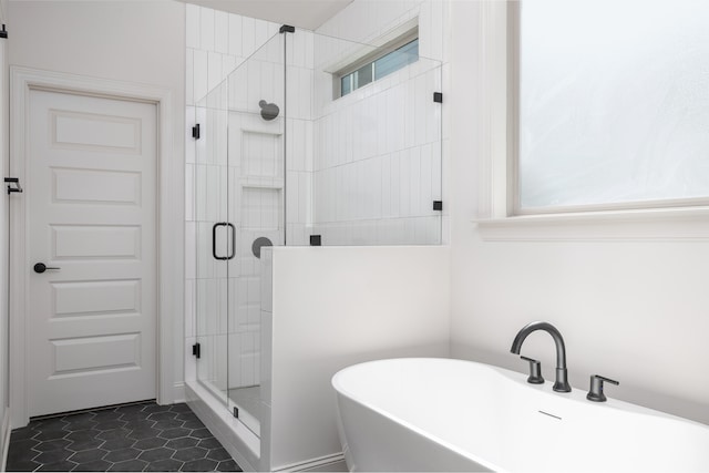 bathroom featuring tile patterned floors and separate shower and tub