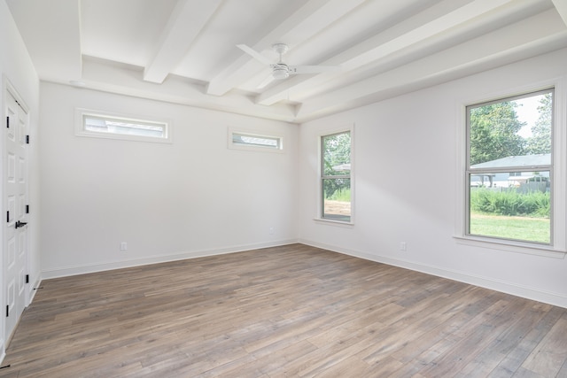 empty room with wood-type flooring, ceiling fan, and beam ceiling