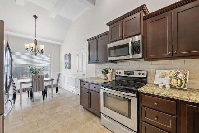 kitchen with vaulted ceiling with beams, stainless steel appliances, dark brown cabinetry, light stone countertops, and decorative light fixtures