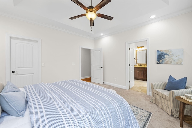 carpeted bedroom featuring crown molding, ceiling fan, and ensuite bath