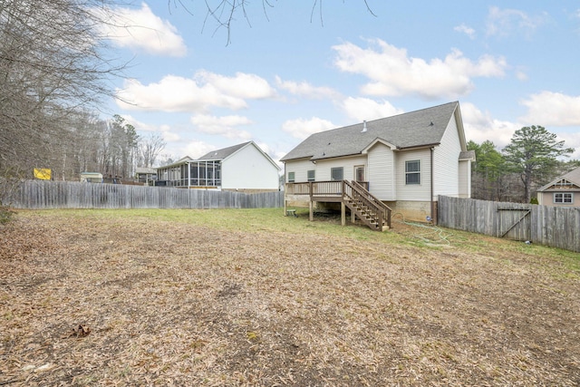 rear view of property with a wooden deck