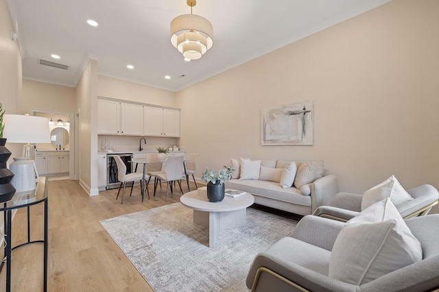 living room with sink and light wood-type flooring