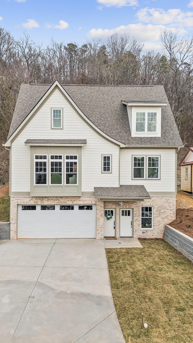 view of front of home featuring a garage and a front lawn