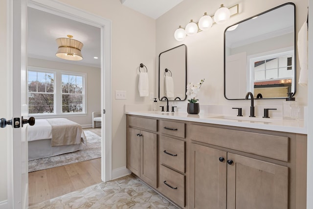 bathroom with ornamental molding and vanity