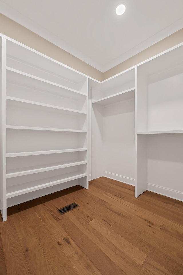 spacious closet featuring hardwood / wood-style floors