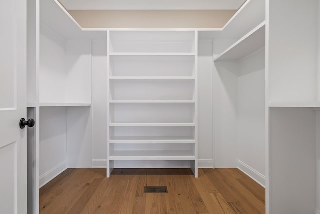 spacious closet with hardwood / wood-style flooring